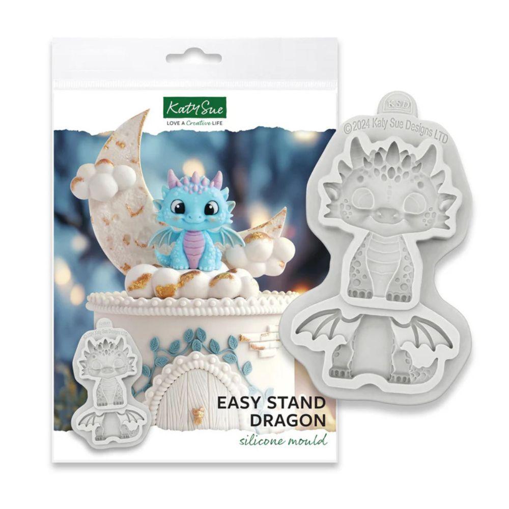 Katy Sue Easy Stand Dragon silikon mold i emballasje med turkis dragefigur på hvit kake med måne