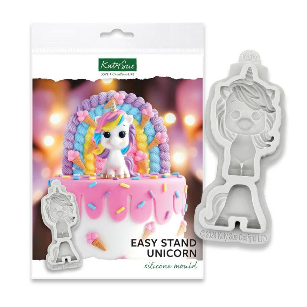 Katy Sue Easy Stand Unicorn silikon mold i emballasje med hvit enhjørning på rosa kake med regnbue