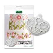 Katy Sue Fabric Flowers & Fancy Leaves silikon mold i emballasje med hvit kake dekorert med rosa sukkerbomster