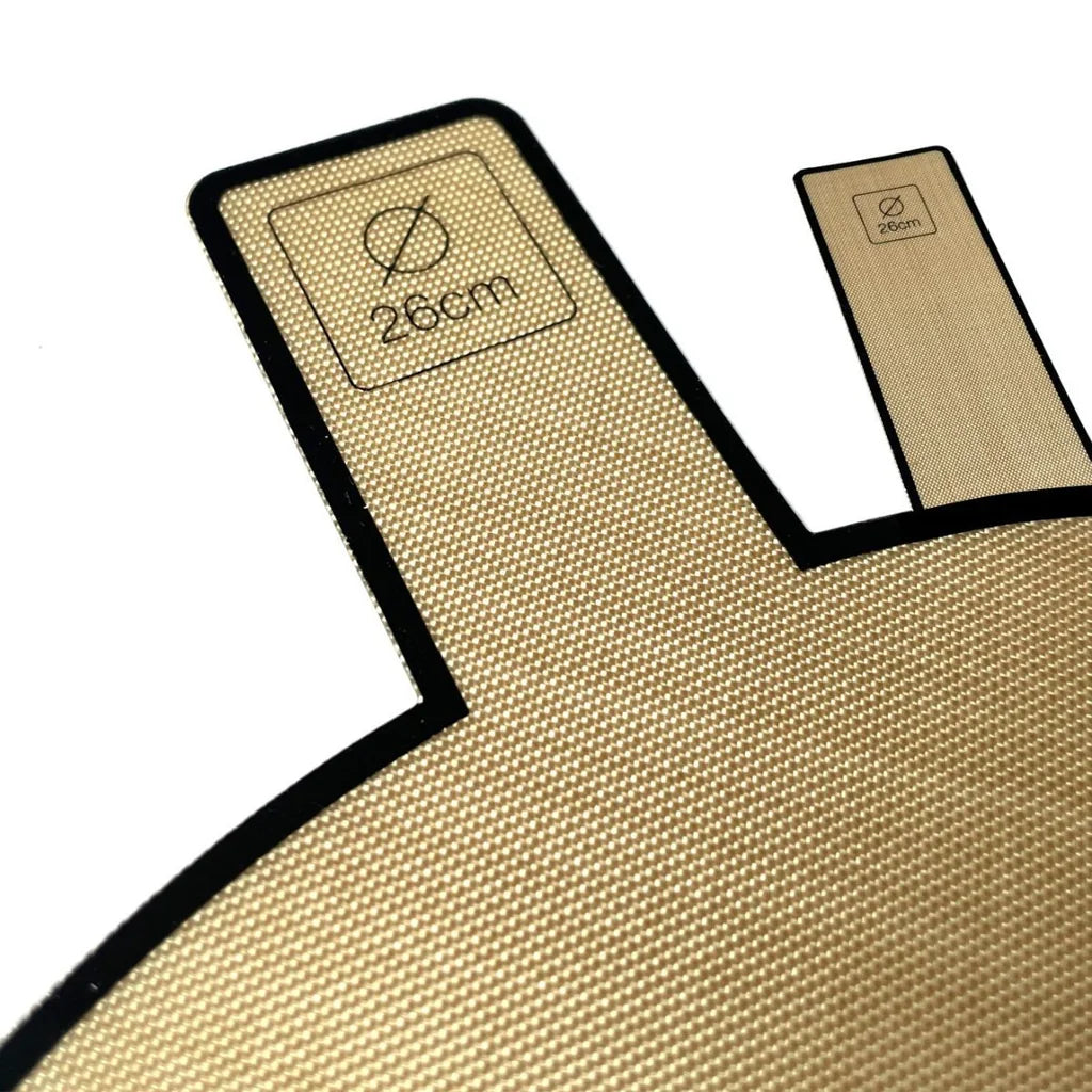 Detalj av bakepapir for Ø26cm form med håndtak og størrelsesmerking