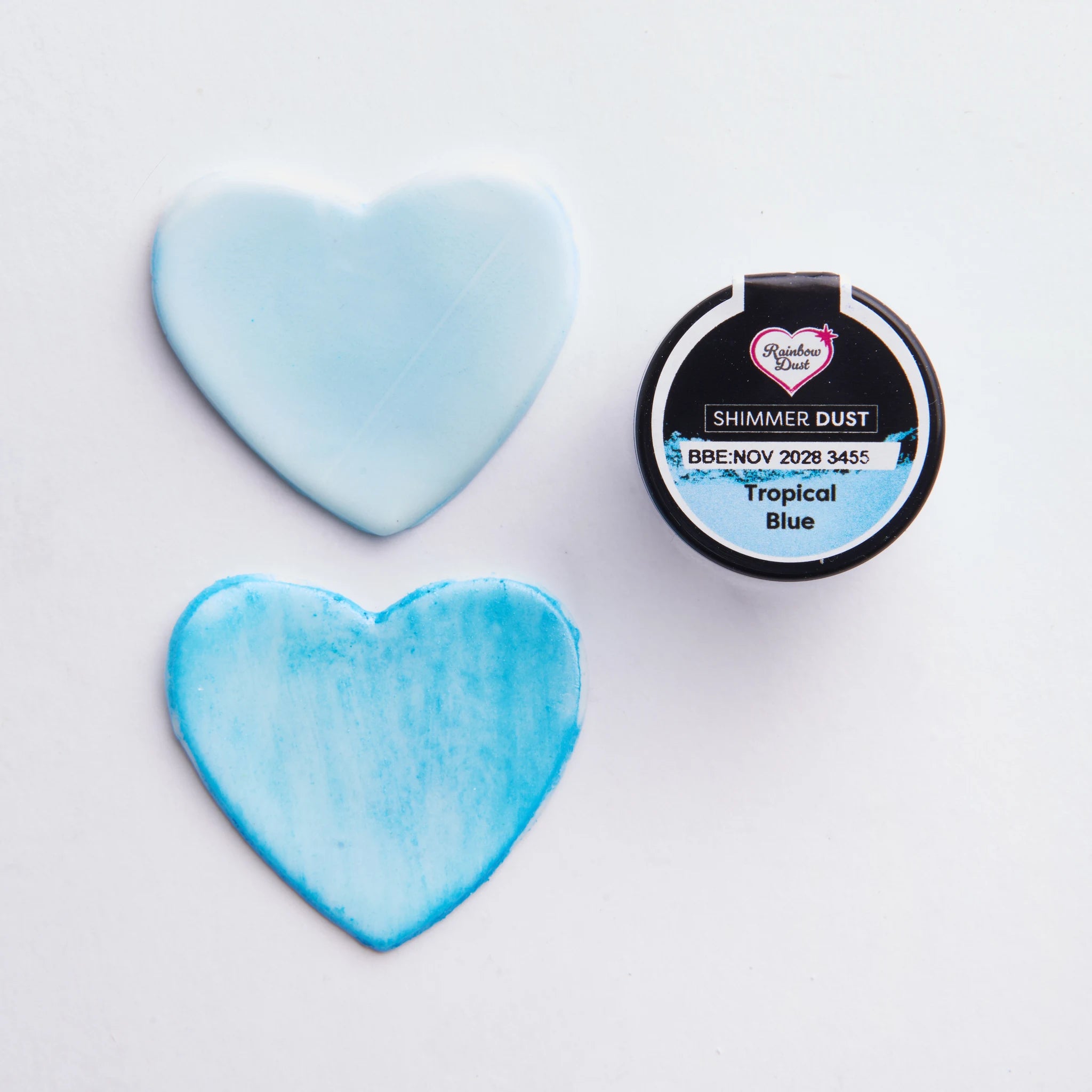 Før og etter-demonstrasjon av Rainbow Dust Tropical Blue lustrepulver på sukkerpasta-hjerter